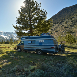 beautiful-shot-female-standing-grassy-field-near-van-with-mountain_2861_2861.jpg