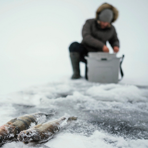 man-getting-ready-fishing-frozen-lake_1170_1170.jpg